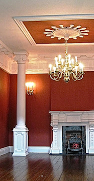 A striking red room designed by Emma Waddell with C12 coving, Columns CM4, pedestals CP6, fireplace PF9 and BBGE3 grate